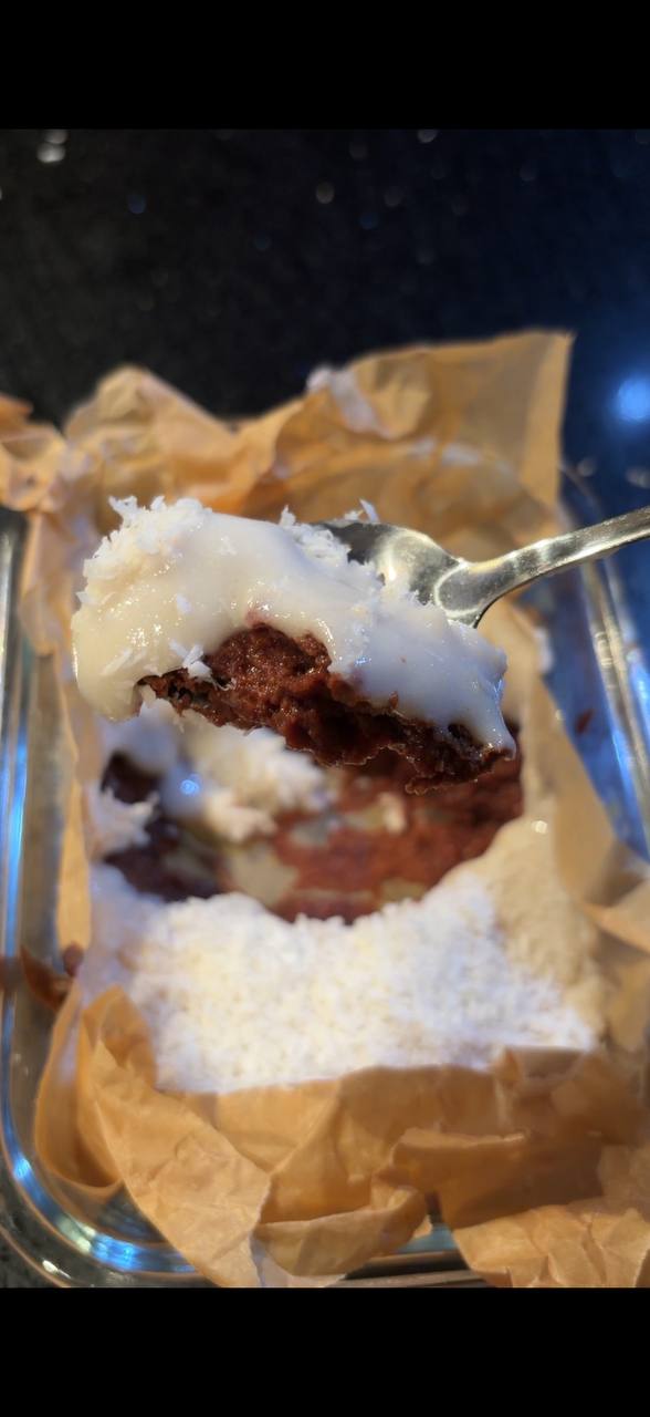 Spoonful of leftover rice chocolate dessert showing cocoa base and creamy layer